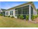 Exterior view of the screened porch, showcasing the home's backyard and landscaping at 1003 Locals St, Summerville, SC 29485
