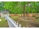 Backyard showing the white picket fence, shed, and large mature trees at 1016 Providence Way, Summerville, SC 29483
