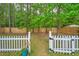 Backyard featuring white picket fence, mature trees and a glimpse of a shed at 1016 Providence Way, Summerville, SC 29483