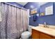 Cozy bathroom with blue walls, a shower with a patterned curtain, and vanity at 1016 Providence Way, Summerville, SC 29483