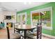 Open dining area with green walls, a round table, and a view to the backyard pool at 1016 Providence Way, Summerville, SC 29483