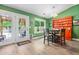 Bright dining area featuring green walls, wood floors, and natural light from French doors and a large window at 1016 Providence Way, Summerville, SC 29483