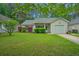 Charming one-story home with a well-manicured lawn, mature trees, and an attached garage at 1016 Providence Way, Summerville, SC 29483