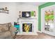 Comfortable living room space with decorative fireplace, TV, and backyard access at 1016 Providence Way, Summerville, SC 29483
