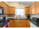 Bright kitchen with stainless steel appliances, granite countertops, and wooden cabinetry at 1016 Providence Way, Summerville, SC 29483