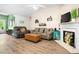 Cozy living room with vaulted ceilings, wood floors, and a fireplace at 1016 Providence Way, Summerville, SC 29483