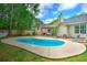 Beautiful backyard pool surrounded by lush greenery and patio, offering a private oasis at 1016 Providence Way, Summerville, SC 29483