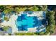 Aerial view of a beautifully designed pool area with plenty of lounge chairs, umbrellas and landscaping at 1025 Riverland Woods Pl # 1023, Charleston, SC 29412