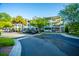 Exterior of a multi-story building with well-maintained landscaping and ample parking spaces at 1025 Riverland Woods Pl # 1023, Charleston, SC 29412
