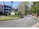 Gated entrance to The Retreat Luxury Condominiums with lush landscaping and multi-story condo buildings in the background at 1025 Riverland Woods Pl # 1023, Charleston, SC 29412