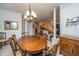 Elegant dining room with a wooden table and chairs, chandelier, and view into the living room at 1025 Riverland Woods Pl # 1023, Charleston, SC 29412