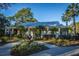 Charming home with a stone fountain in the front yard surrounded by manicured landscaping and mature palm trees at 1025 Riverland Woods Pl # 1023, Charleston, SC 29412
