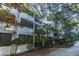 Exterior view of the property showcases private balconies and lush, mature trees at 1025 Riverland Woods Pl # 1023, Charleston, SC 29412