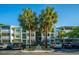 Exterior shot of condos featuring lush landscaping, palm trees, and ample parking at 1025 Riverland Woods Pl # 1023, Charleston, SC 29412