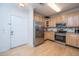 Well-equipped kitchen with stainless steel appliances, natural wood cabinets, and a door to the hallway at 1025 Riverland Woods Pl # 1023, Charleston, SC 29412