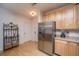 Well-lit kitchen featuring stainless steel appliances, wooden cabinets, and a decorative wine rack at 1025 Riverland Woods Pl # 1023, Charleston, SC 29412