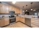 Charming kitchen with stainless steel appliances, wooden cabinets, and hardwood floors at 1025 Riverland Woods Pl # 1023, Charleston, SC 29412