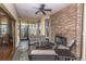 Cozy sunroom with a stone fireplace, comfortable seating, and views of the surrounding outdoor landscape at 1025 Riverland Woods Pl # 1023, Charleston, SC 29412