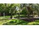 Landscaped backyard with a water fountain and mature palm tree at 104 Waccamaw Dr, Summerville, SC 29485