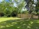 Large, level backyard featuring a new wooden fence and plenty of shade trees at 104 Waccamaw Dr, Summerville, SC 29485