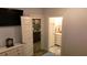 Bedroom view through doorway into ensuite bath featuring marble floors, granite countertops and gold fixtures at 104 Waccamaw Dr, Summerville, SC 29485