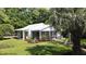 Charming home with screened porch, lush landscaping, and a beautiful lawn at 104 Waccamaw Dr, Summerville, SC 29485