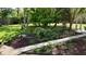 Well-manicured garden with flowers, bench, and a brick walkway at 104 Waccamaw Dr, Summerville, SC 29485