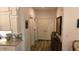 The hallway has wood-look floors, a decorative table with flowers, and art hanging on the wall at 104 Waccamaw Dr, Summerville, SC 29485