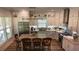 Bright kitchen with white cabinetry, granite countertops, stainless steel appliances, and an island with bar stools at 104 Waccamaw Dr, Summerville, SC 29485
