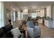 A bright living room opens to a kitchen with white cabinets, granite countertops, and stainless steel appliances at 104 Waccamaw Dr, Summerville, SC 29485