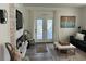 Bright living room features a stone fireplace, a TV, and glass doors leading to an outside view at 104 Waccamaw Dr, Summerville, SC 29485