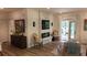 The living room is bright with a stone fireplace, TV, and a glass door leading to the outside at 104 Waccamaw Dr, Summerville, SC 29485