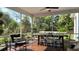Outdoor seating on screened porch with dining area and lush yard at 104 Waccamaw Dr, Summerville, SC 29485