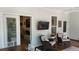 Inviting porch features rocking chairs, a TV, and a view into the home's living area with a fireplace at 104 Waccamaw Dr, Summerville, SC 29485