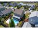 Aerial shot of a two-story home with a pool, screened porch, landscaping, and fenced in backyard at 1097 Briar Rose Ln, Ladson, SC 29456