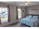 Bedroom with gray walls, ceiling fan, bed, two windows, and bedside table at 1097 Briar Rose Ln, Ladson, SC 29456