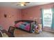Bedroom with pink walls, ceiling fan, bed, window, and desk at 1097 Briar Rose Ln, Ladson, SC 29456