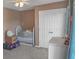 Bedroom with tan walls, ceiling fan, crib, closet, and dresser at 1097 Briar Rose Ln, Ladson, SC 29456