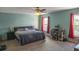 Bedroom features light blue walls, ceiling fan, a large bed and red curtains at 1097 Briar Rose Ln, Ladson, SC 29456