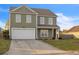 Charming two-story home with a well-maintained lawn and attached two-car garage for ample parking at 1097 Briar Rose Ln, Ladson, SC 29456