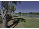 Scenic view of the community's pond, bordered by mature trees and a walking path at 1097 Briar Rose Ln, Ladson, SC 29456