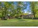 Expansive backyard with a shed, fire pit, mature trees and ample green space at 114 California Ave, Moncks Corner, SC 29461