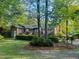 Beautiful backyard showcasing a well-maintained lawn and brick home with a spacious deck at 114 California Ave, Moncks Corner, SC 29461