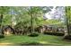 Spacious backyard with a shed, fire pit area, mature trees and a well-maintained lawn at 114 California Ave, Moncks Corner, SC 29461