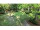 Lush backyard featuring mature trees, green grass, and landscaping elements at 114 California Ave, Moncks Corner, SC 29461