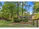 Lush backyard with mature trees, manicured landscaping and a shed at 114 California Ave, Moncks Corner, SC 29461
