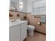 Traditional bathroom with a white sink, toilet, decorative wall tiles and a window providing natural light at 114 California Ave, Moncks Corner, SC 29461