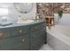 Bathroom with marble tile and exposed brick, with a vintage sink and gold fixtures at 114 California Ave, Moncks Corner, SC 29461
