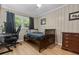 Charming bedroom featuring wood floors, a comfortable bed, a desk, and a ceiling fan at 114 California Ave, Moncks Corner, SC 29461