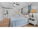 Well-lit bedroom with hardwood floors, soft blue accents, and en-suite bathroom entrance at 114 California Ave, Moncks Corner, SC 29461